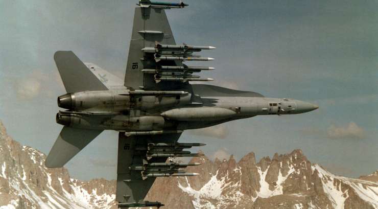F/A-18 fighter jet equipped with AIM-9 and AIM-120 missiles mounted on LAU-127 launchers.