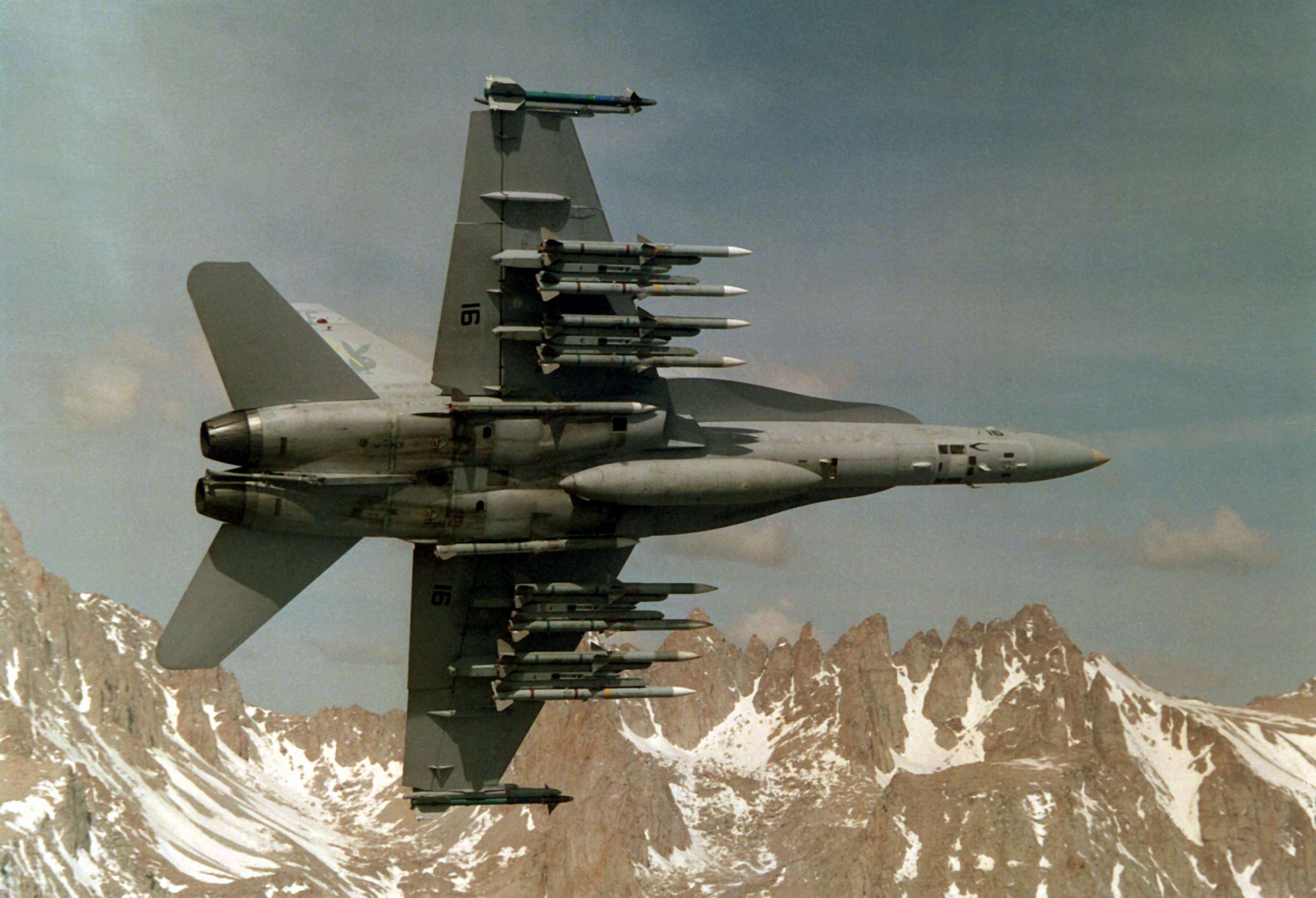 F/A-18 fighter jet equipped with AIM-9 and AIM-120 missiles mounted on LAU-127 launchers.